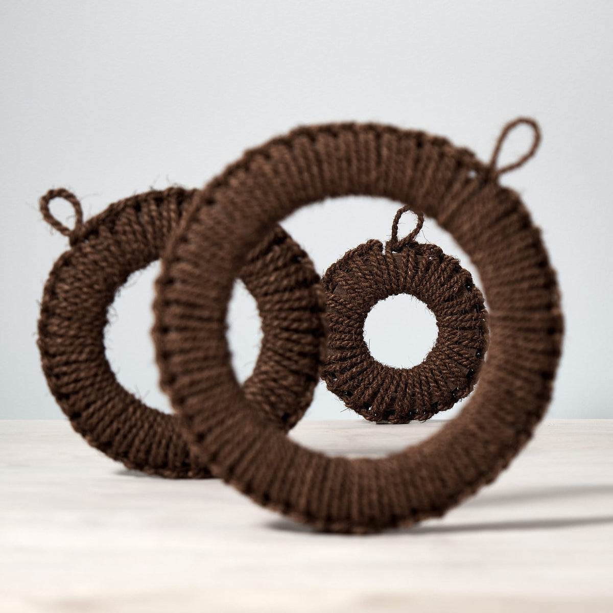 Three Hand-Knit Trivet – Small ornaments by Takada on a table.