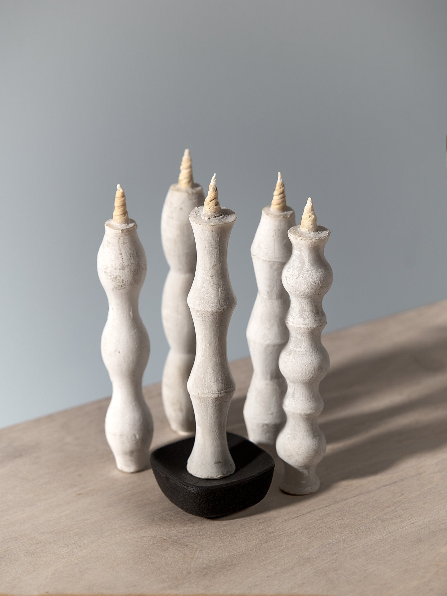 A group of Takazawa NANAO – 5 Piece Mixed Box Set candle holders on a table.
