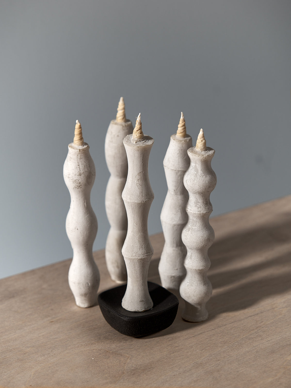 Four NANAO-P candle holders on a wooden table. (Brand: Takazawa)