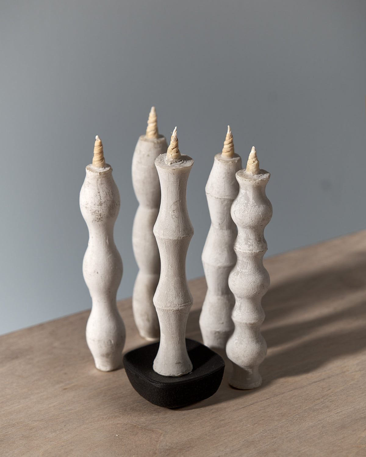 Four NANAO-P candle holders on a wooden table. (Brand: Takazawa)