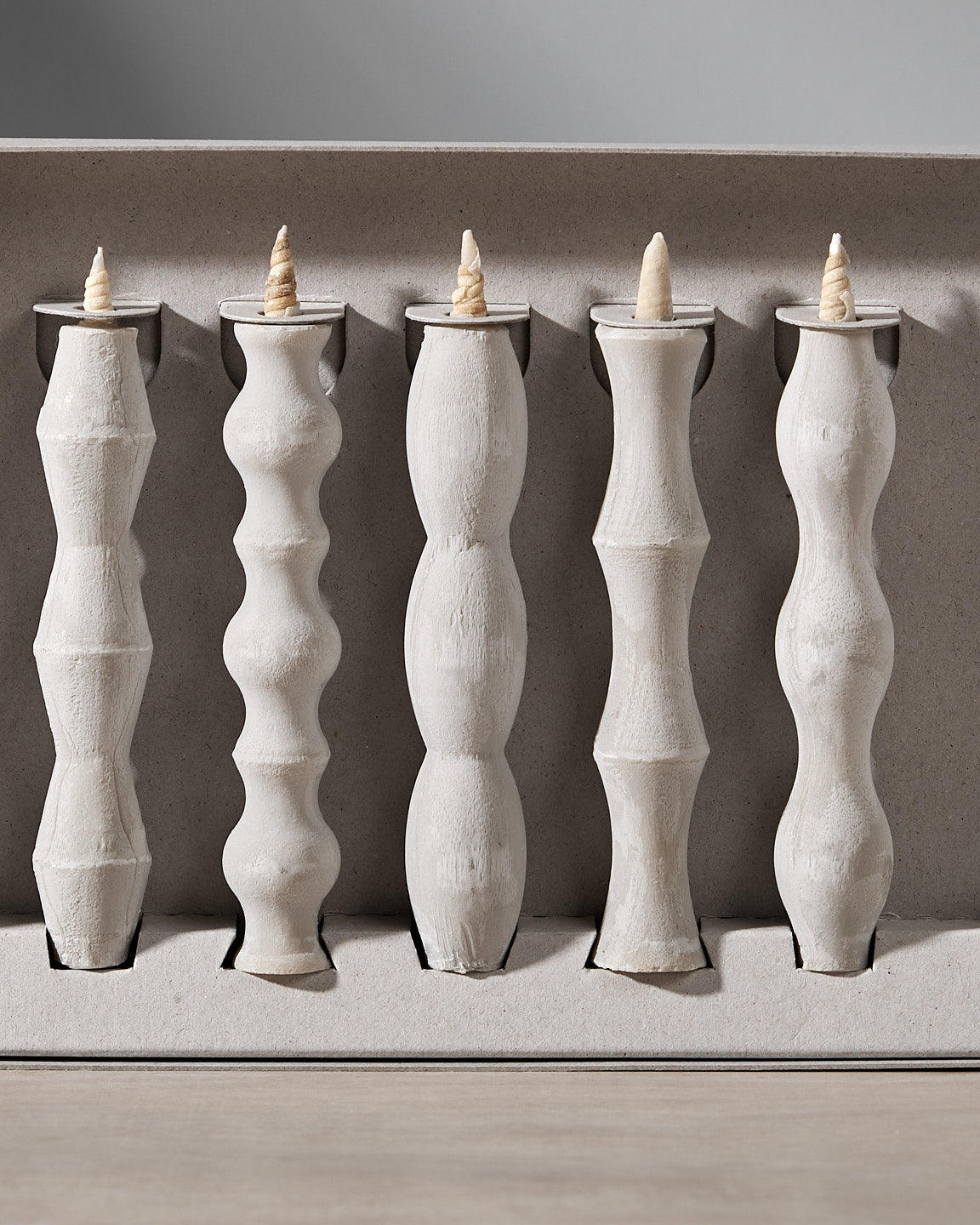 A group of Takazawa NANAO – 5 Piece Mixed Box Set candle holders on a table.