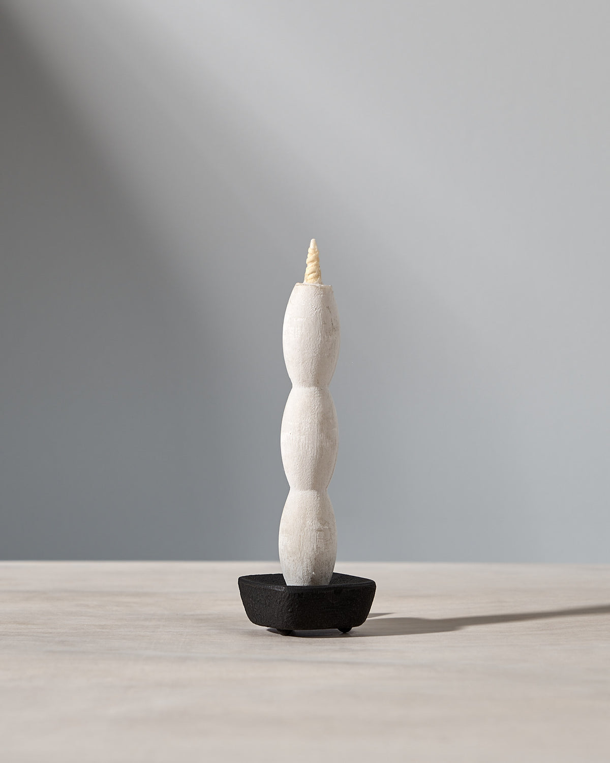 A NANAO – 5 Piece Mixed Box Set candle sitting on top of a wooden table, manufactured by Takazawa.