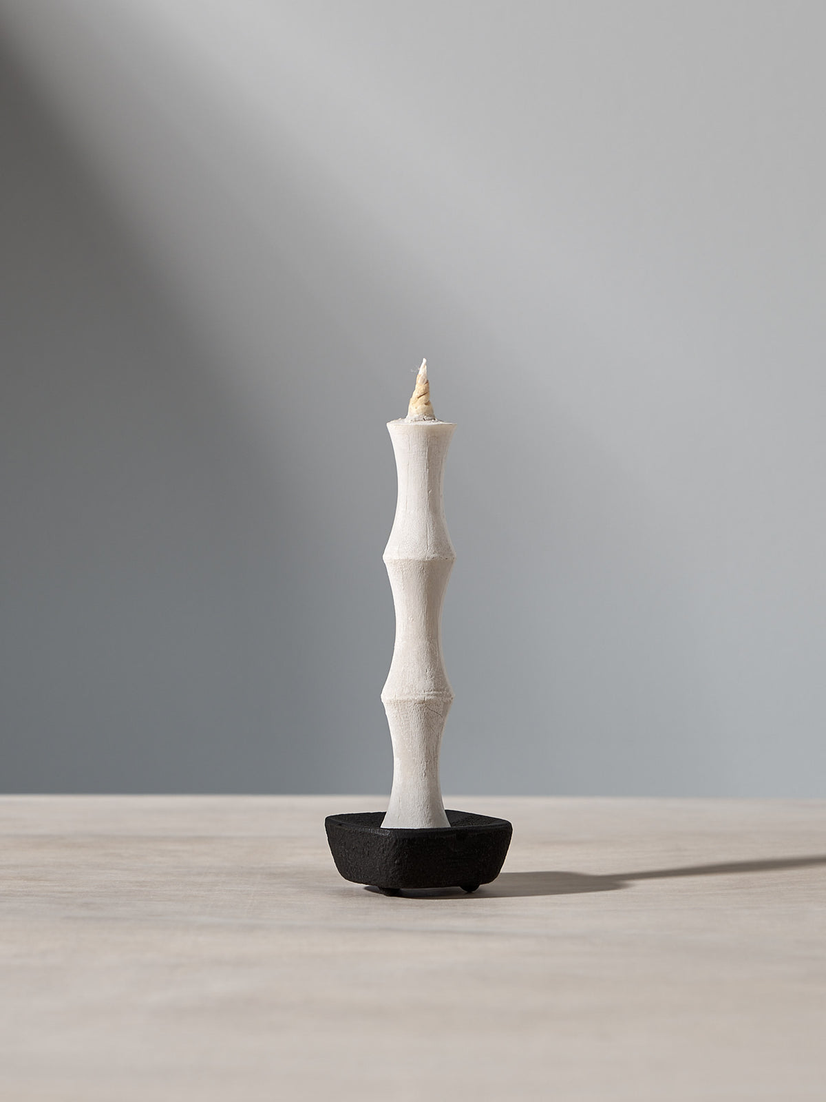 A NANAO – 5 Piece Mixed Box Set candle sitting on top of a wooden table, made by Takazawa.