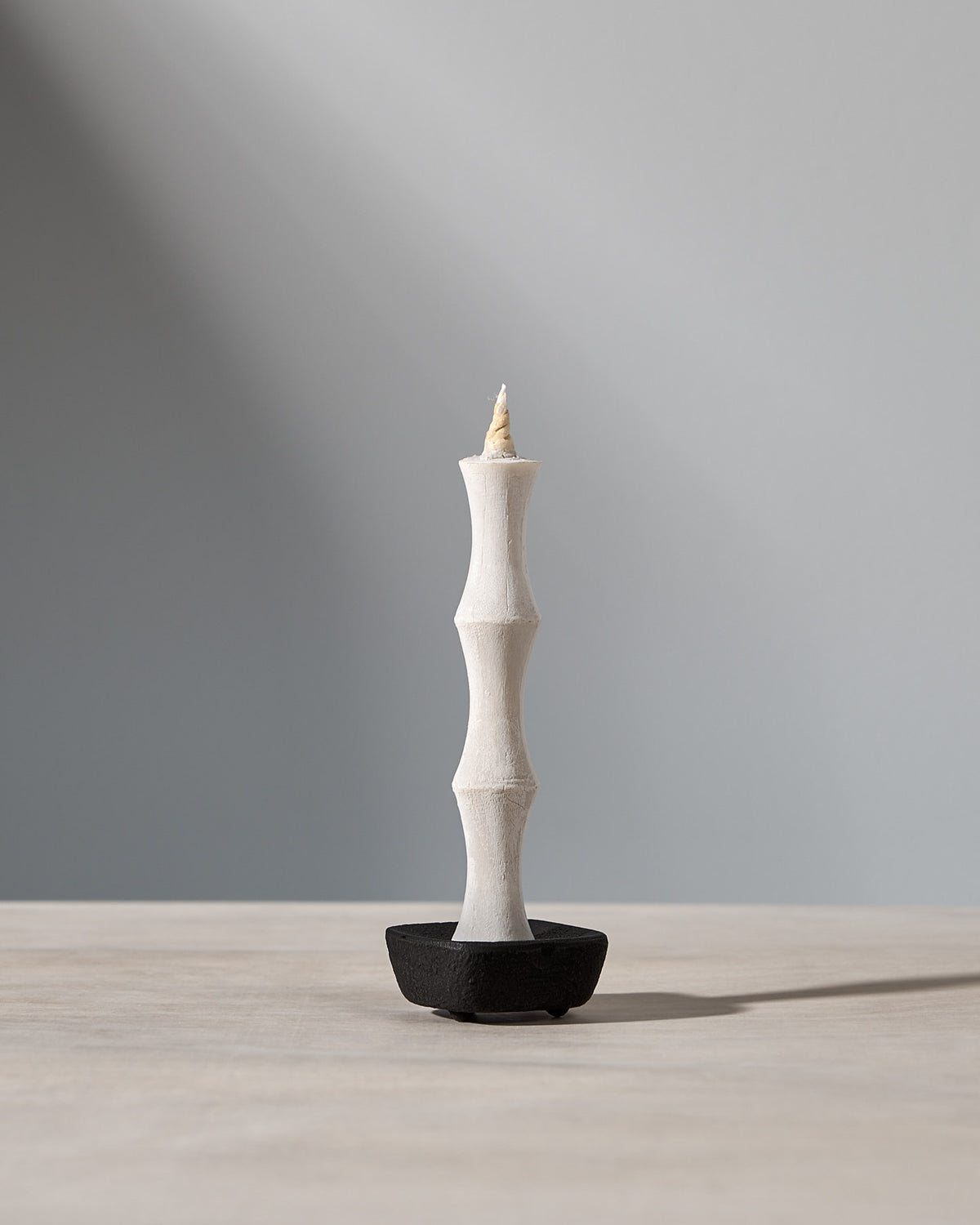 A NANAO – 5 Piece Mixed Box Set candle sitting on top of a wooden table, made by Takazawa.