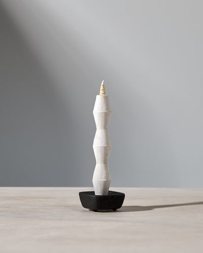 A NANAO-P candle sitting on top of a Takazawa wooden table.