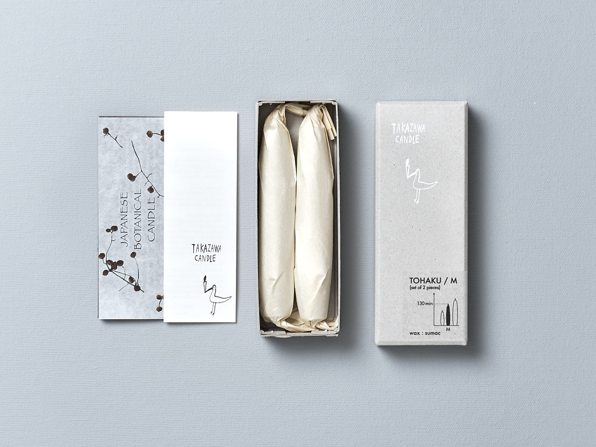A white box with a TOHAKU Candles - Medium (box of 2) inside, made by Takazawa.