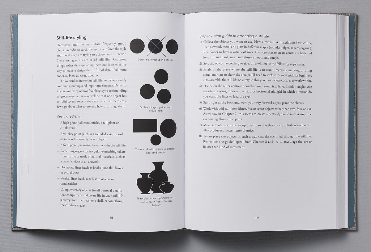 An open book featuring a black and white drawing of a vase, showcasing a professional touch in successful interior design - The Interior Design Handbook by Frida Ramstedt, showcasing Frida Ramstedt&#39;s professional touch in successful interior design.