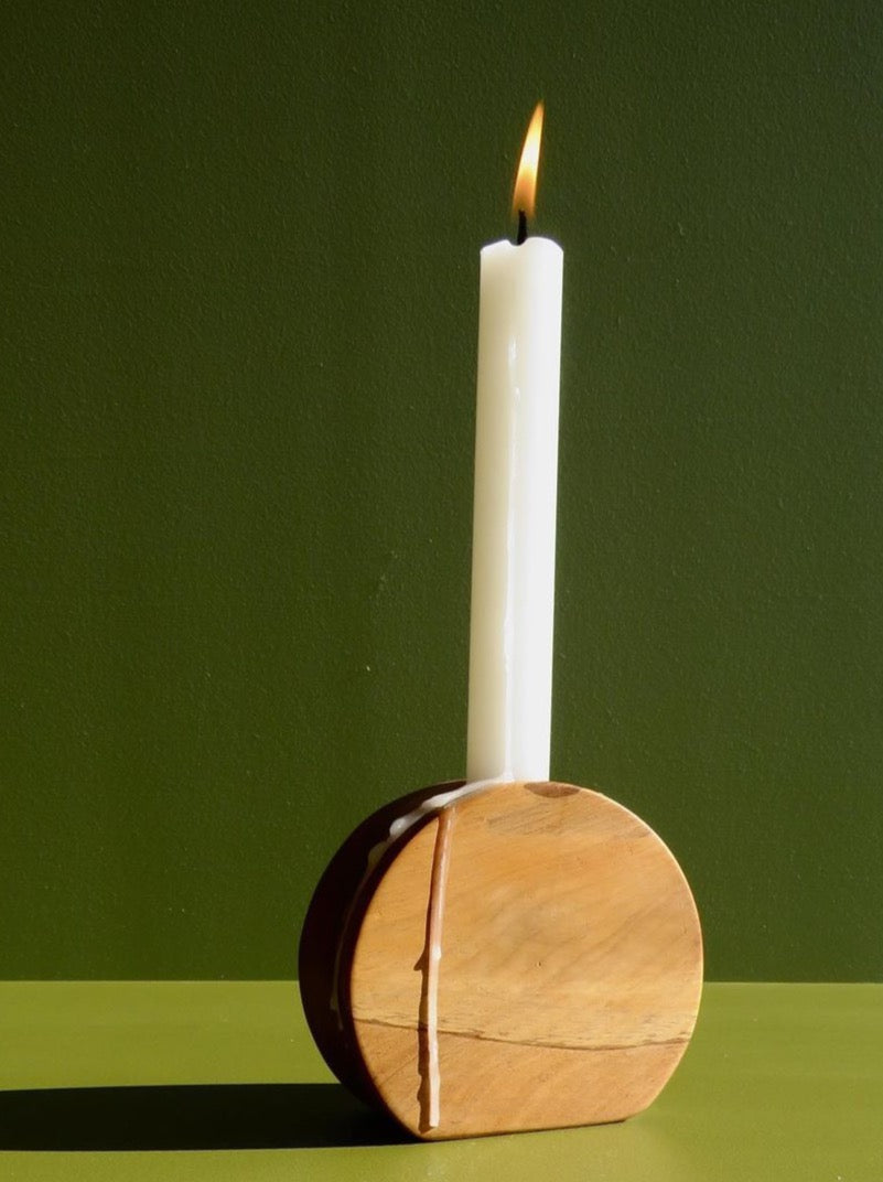 An Orb Candle Holder with a candle inside by The River.