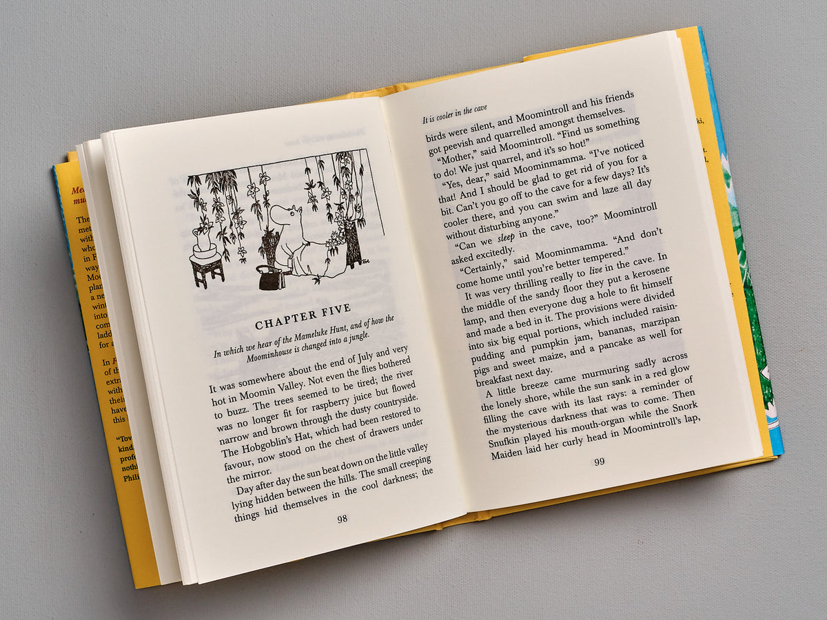 An open Finn Family Moomintroll book with a picture of a man and a woman, by Tove Jansson.