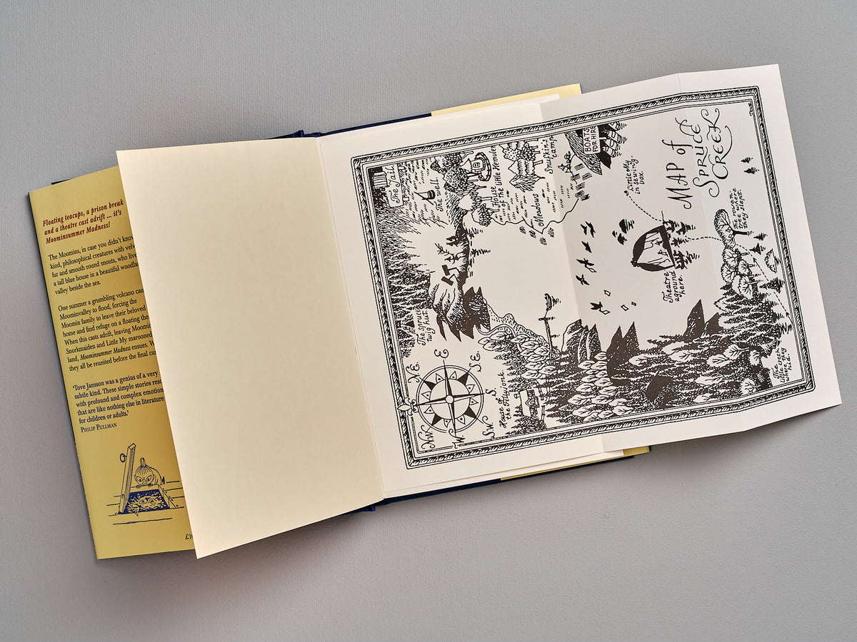 An open Moominsummer Madness book with a drawing on it by Tove Jansson.