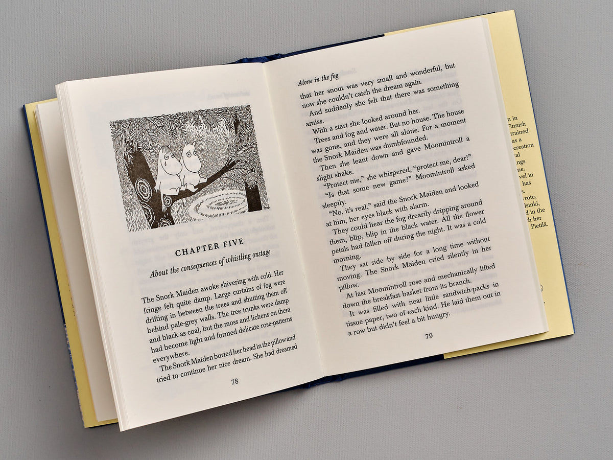 A Moominsummer Madness by Tove Jansson is open with a picture of a boy and a girl.