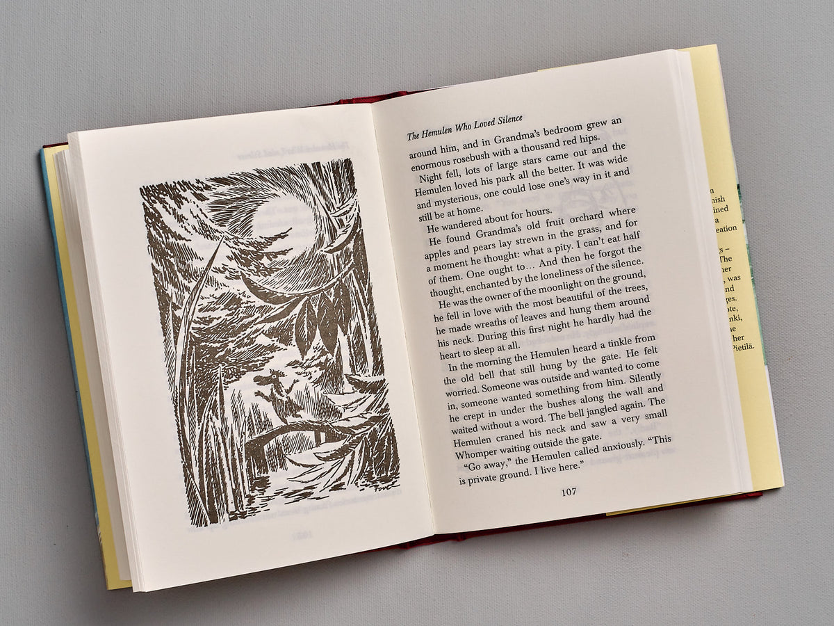 An open book with an illustration of Tales From Moominvalley by Tove Jansson.