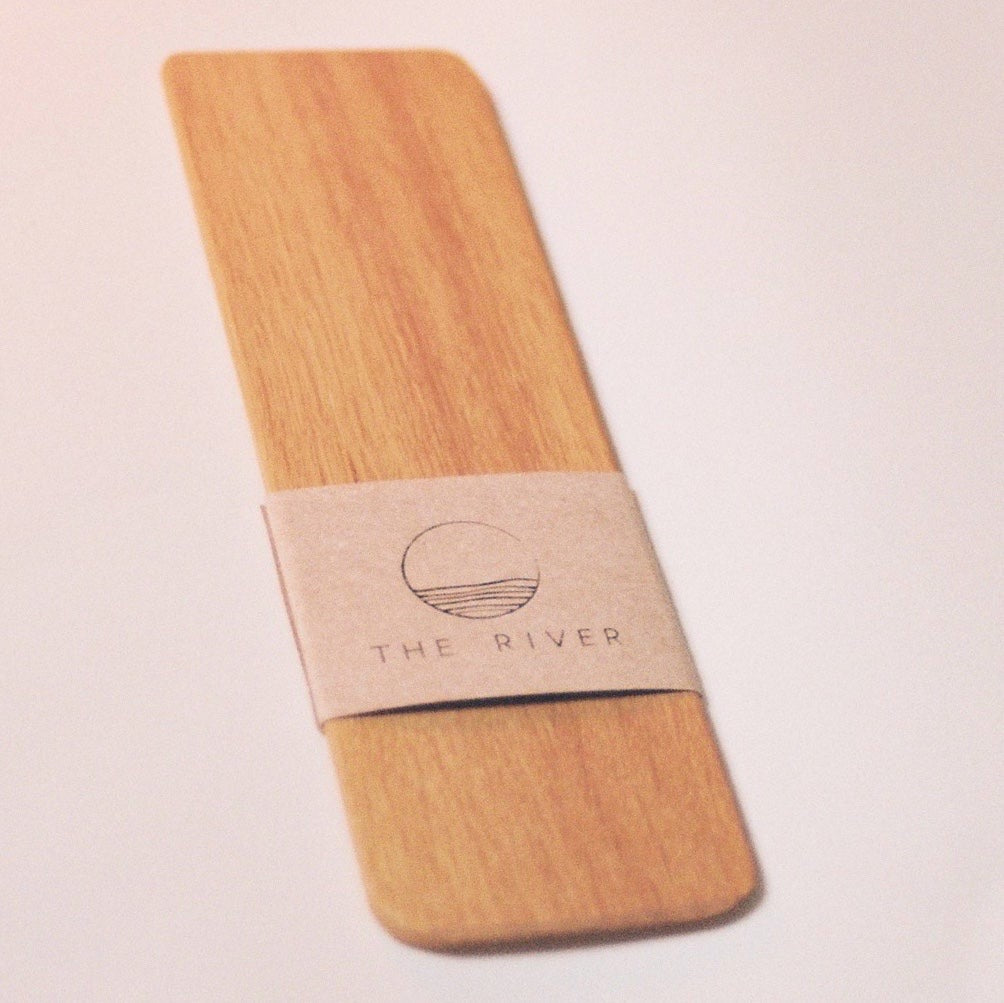 A &quot;Bookmark - Oak&quot; coaster with a label by &quot;The River&quot; brand.