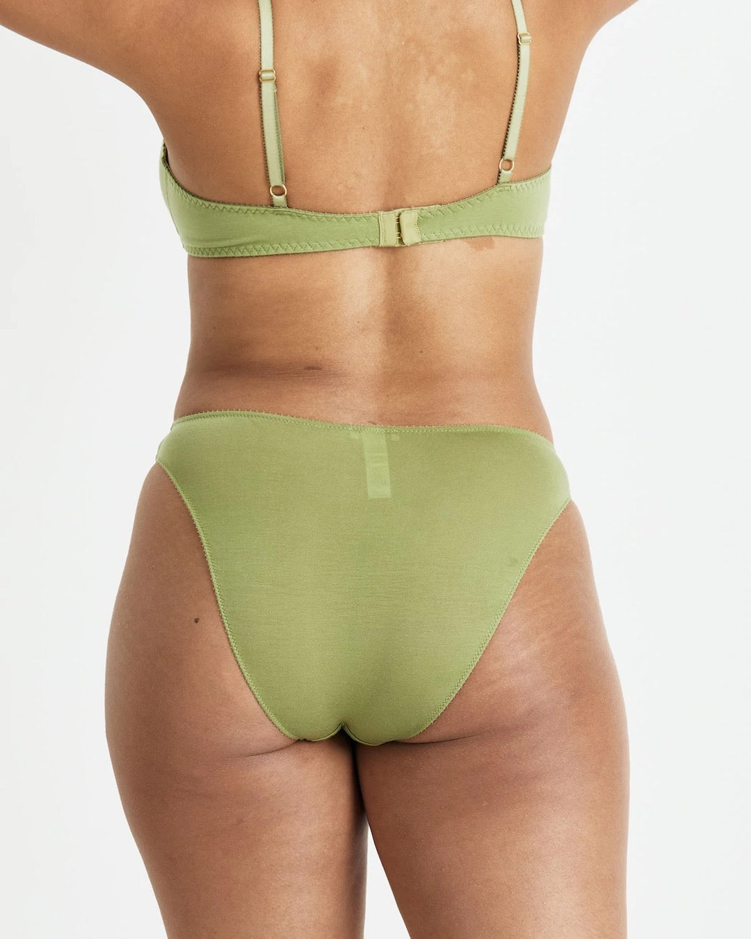 The back view of a woman wearing the Videris Angela Bra – Olive in a green bikini.
