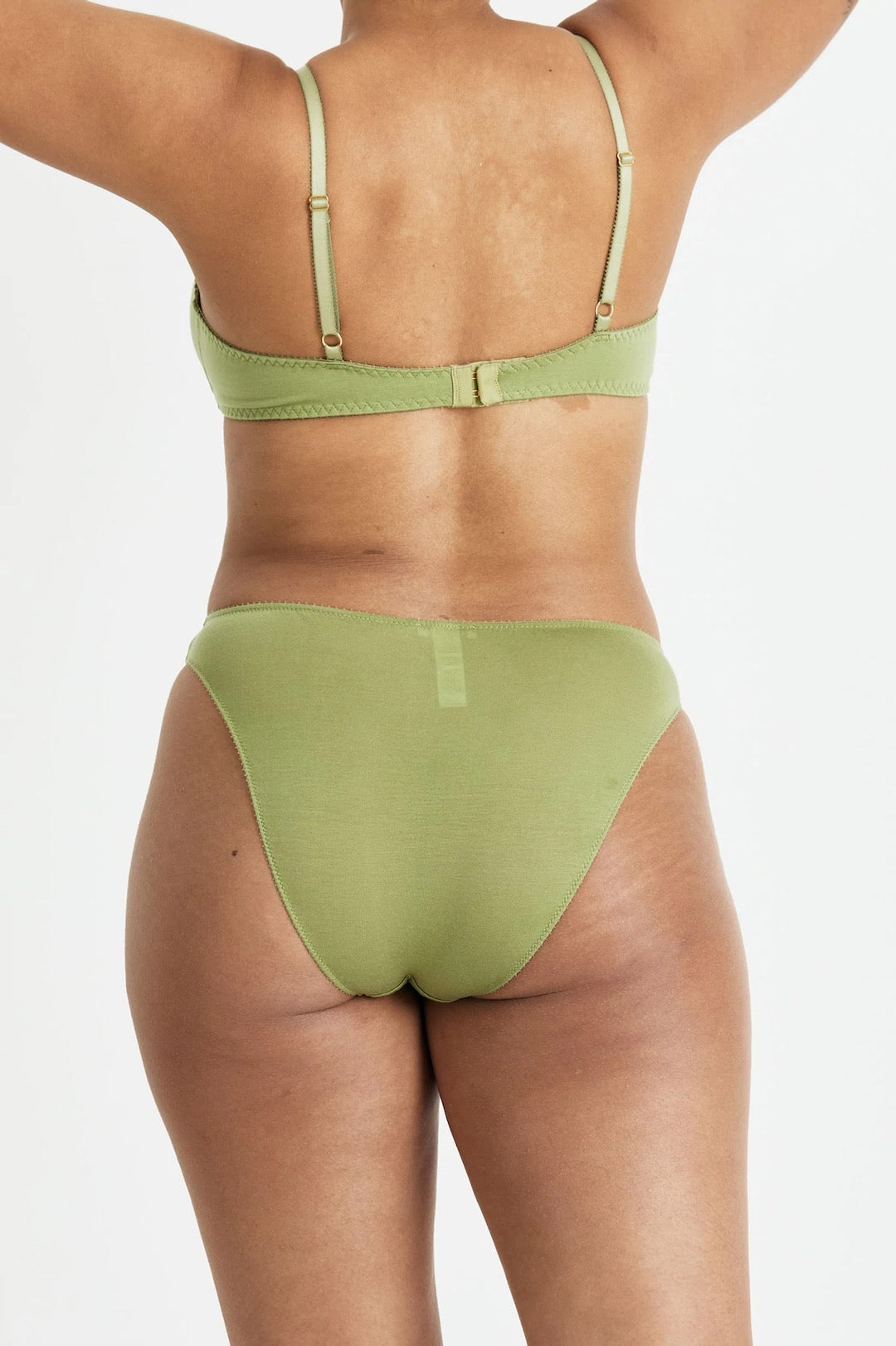 The back view of a woman wearing the Videris Angela Bra – Olive in a green bikini.