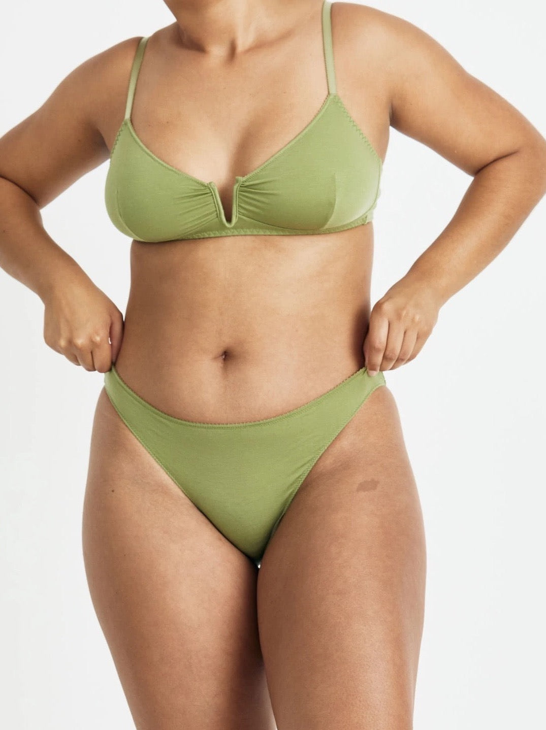 A woman in the Videris Angela Bra – Olive bikini top and bottom.