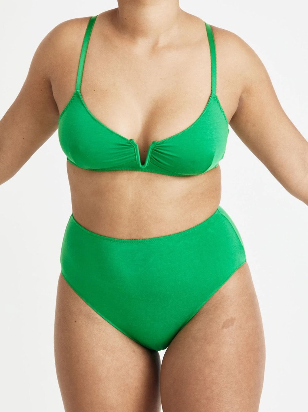 A woman in a green Angela Bra – Poise by Videris bikini top and bottom.