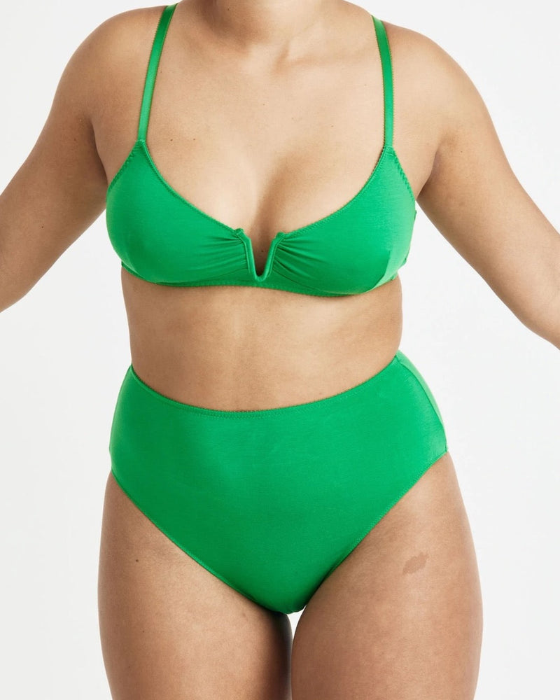 A woman in a green Angela Bra – Poise by Videris bikini top and bottom.