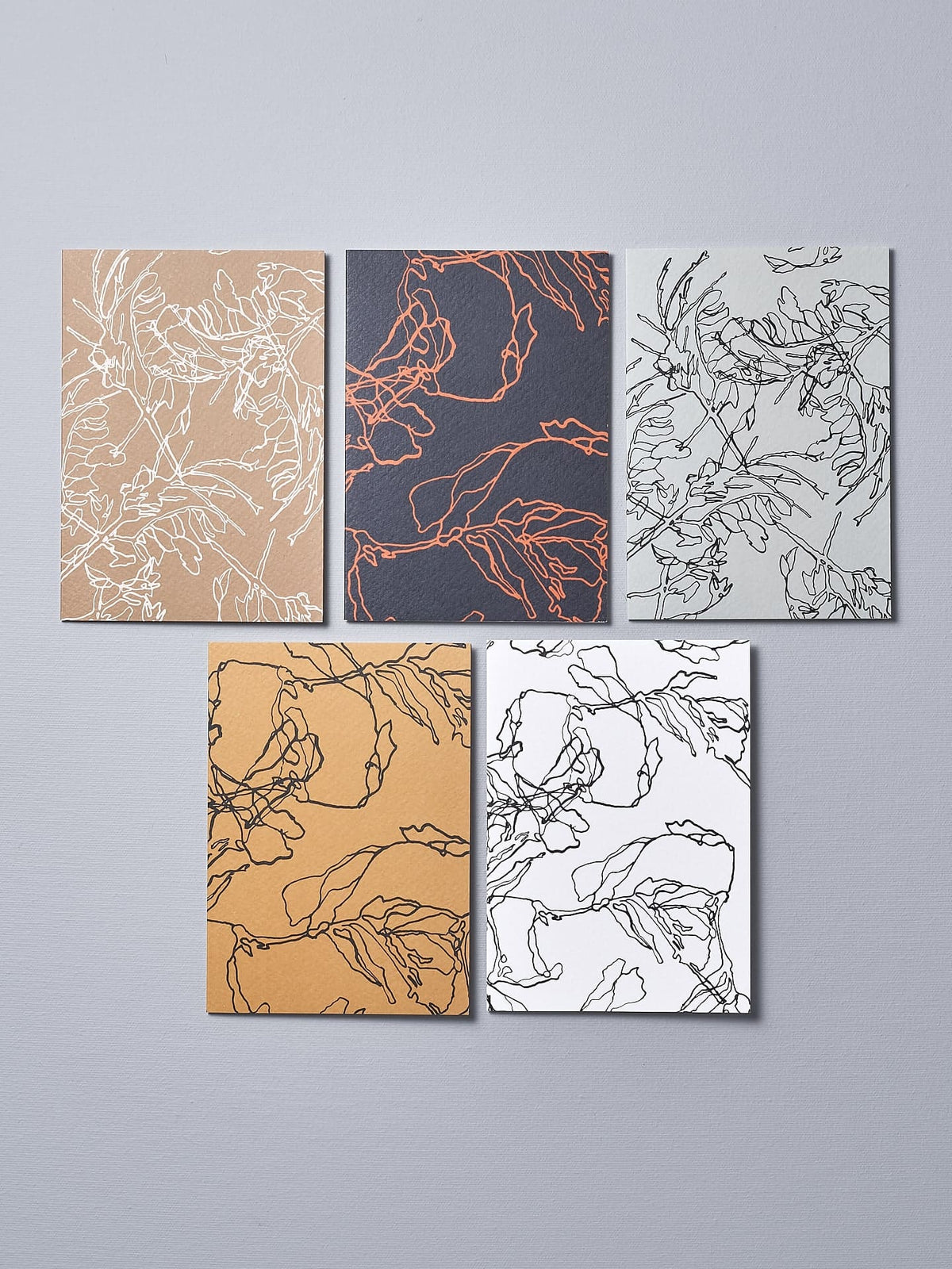 A set of four Walker &amp; Bing Greeting Cards – Floral Outline with different designs on them.