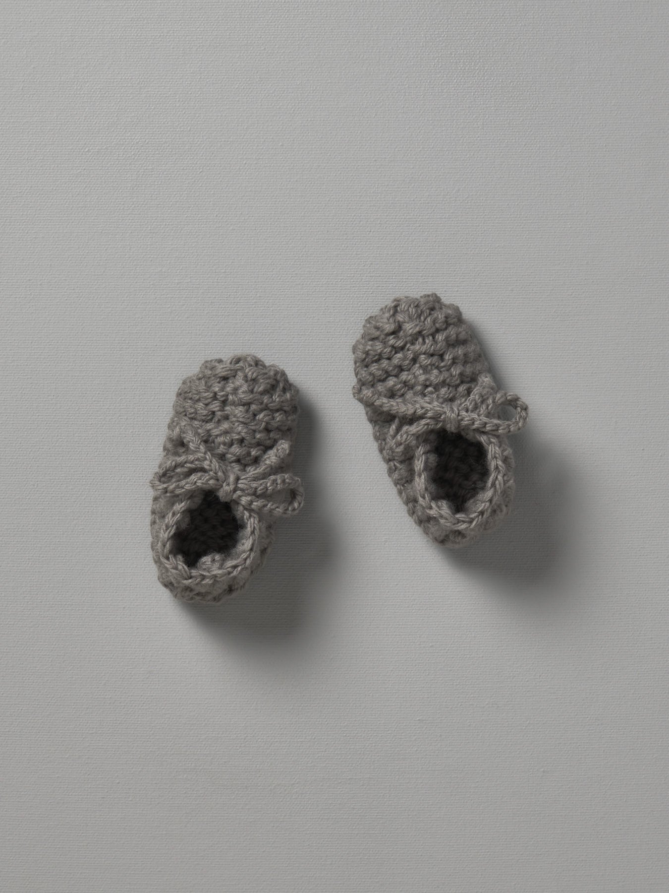 A pair of Weebits Hand Knitted Chunky Booties in Mushroom color on a white surface.