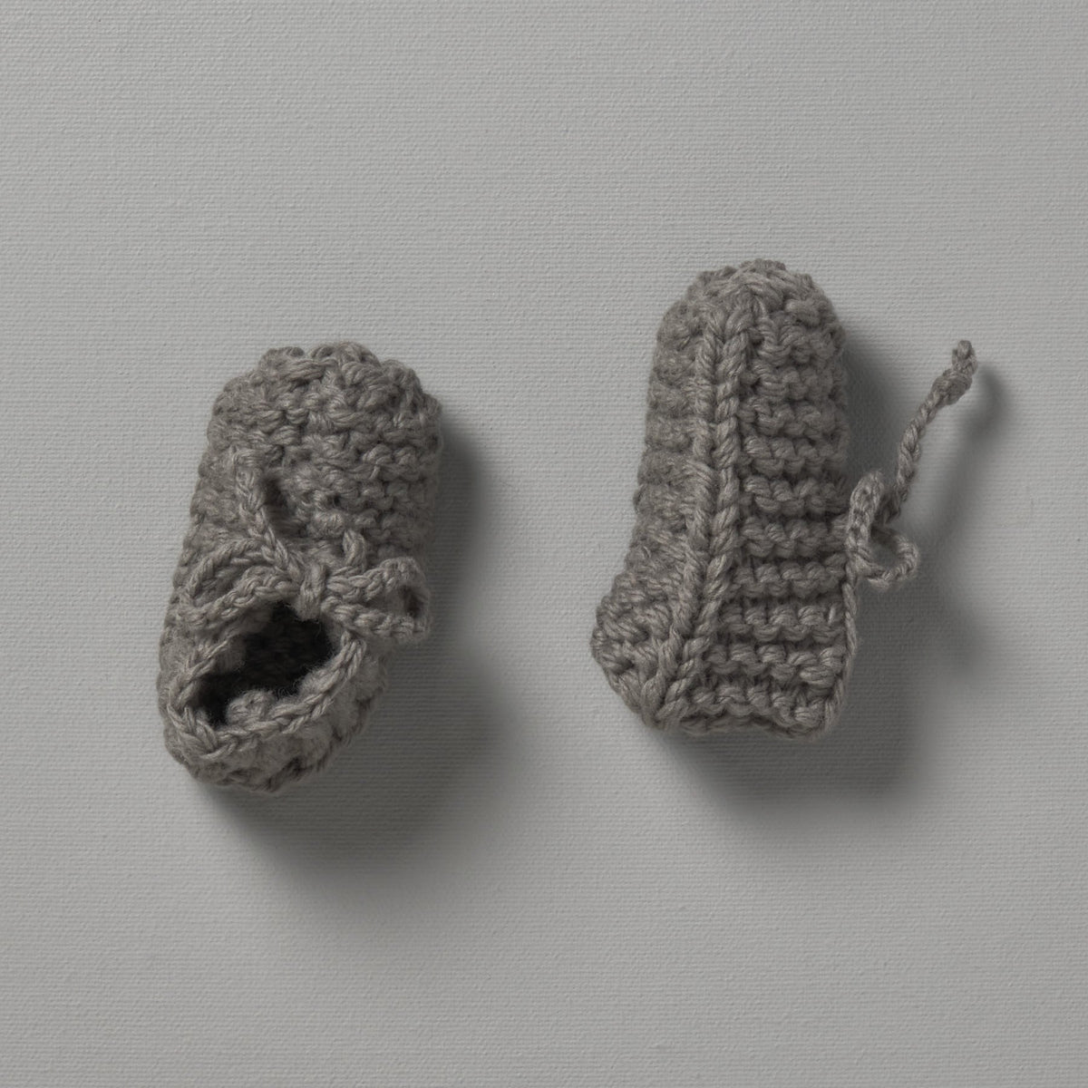 Two Weebits Hand Knitted Chunky Mushroom Booties on a white surface.
