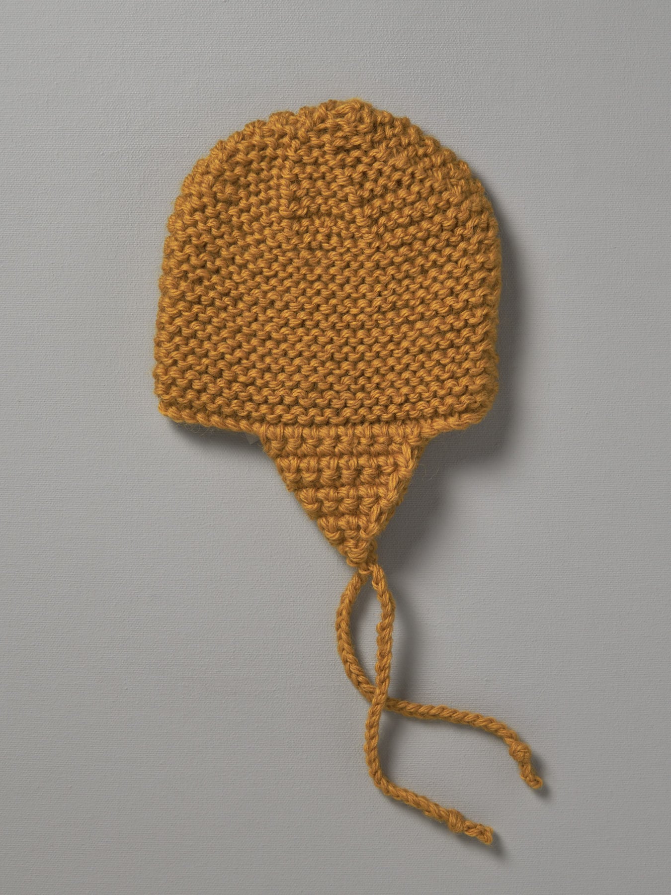 A yellow Hand Knitted Chunky Knit Hat - Mustard by Weebits on a white background.