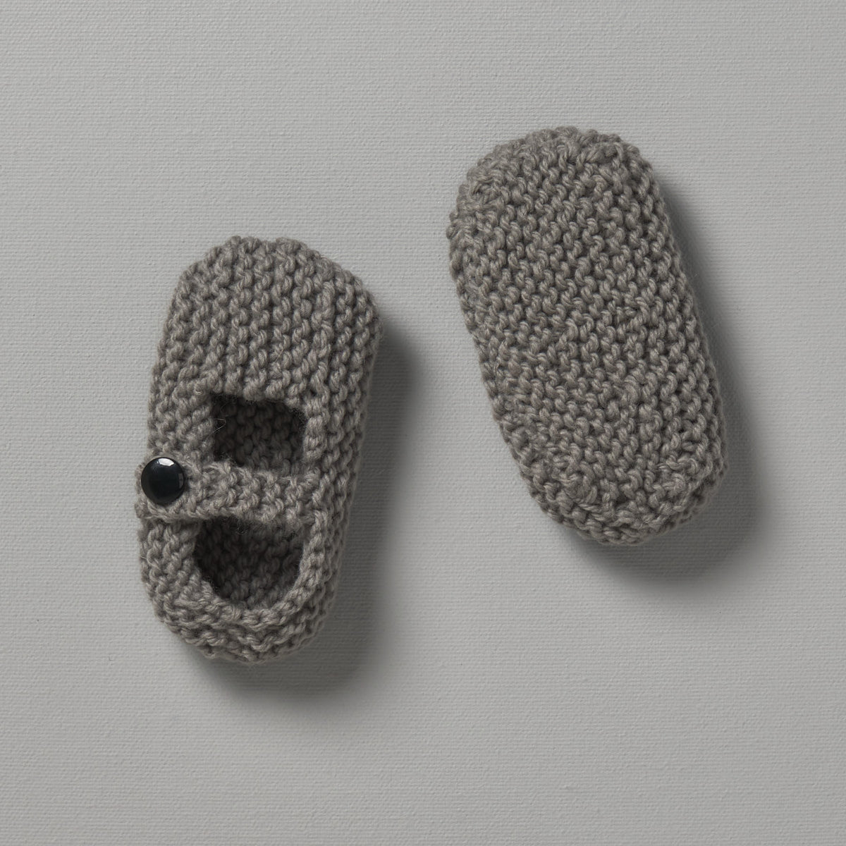 A pair of Weebits Hand Knitted Mary Jane Shoes in Mushroom color on a white surface.