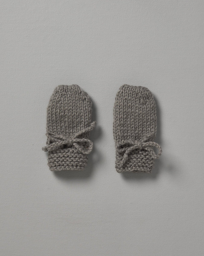 Two grey Weebits Hand Knitted Mittens on a white surface.