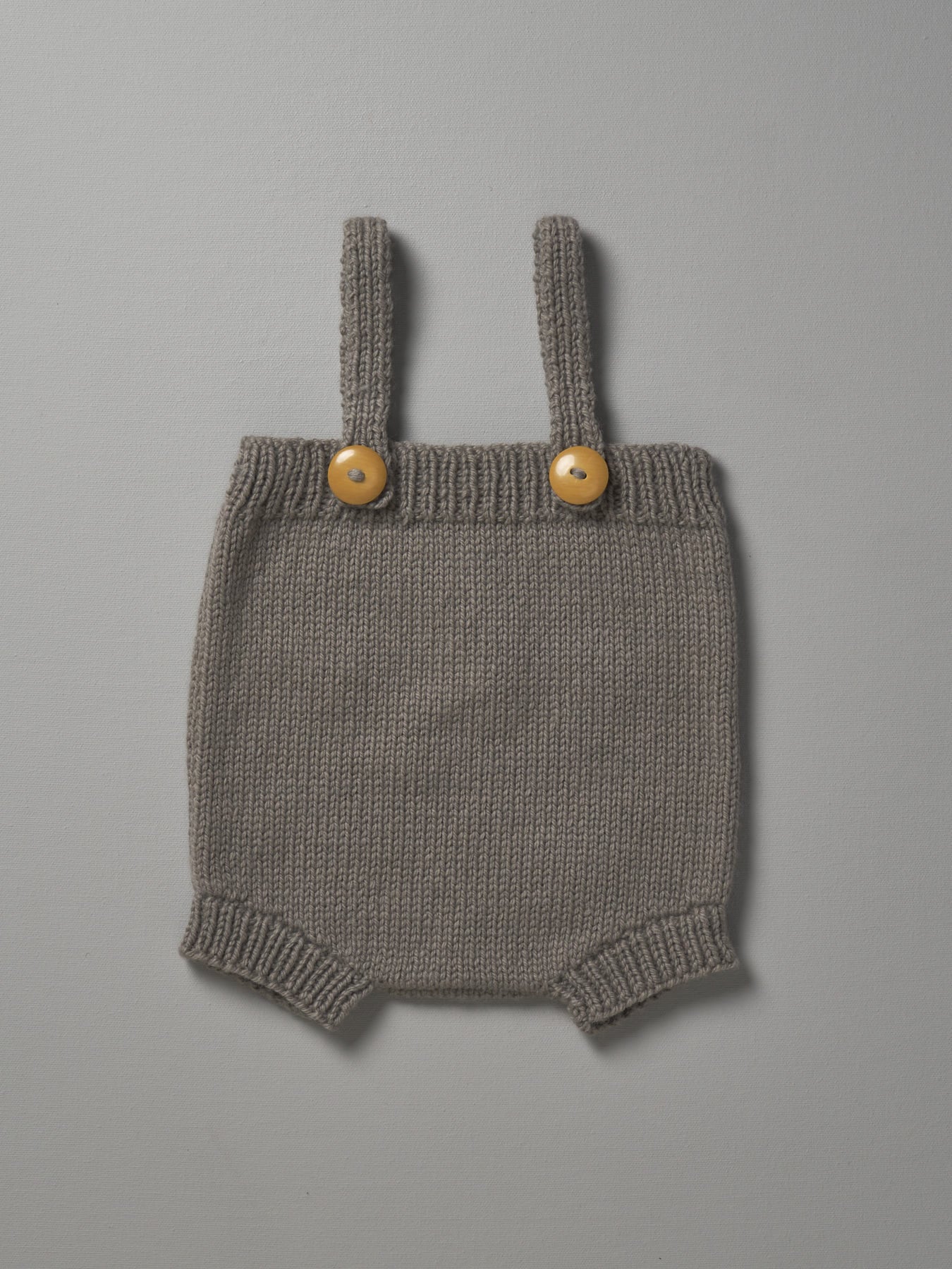 A grey Hand Knitted Romper - Mushroom with gold buttons by Weebits.