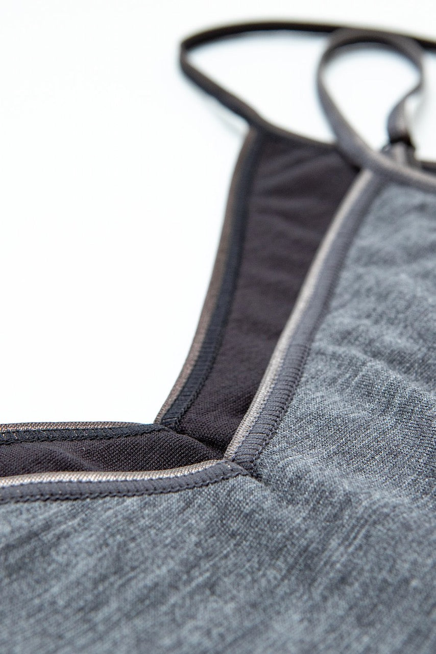 A close up of a Kereru Merino Camisole - Dark Grey sports bra by YARN nz.