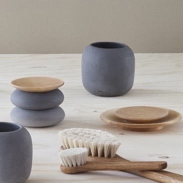 A set of grey ceramic mugs and a Wooden Plate - Large by Iris Hantverk on a table.