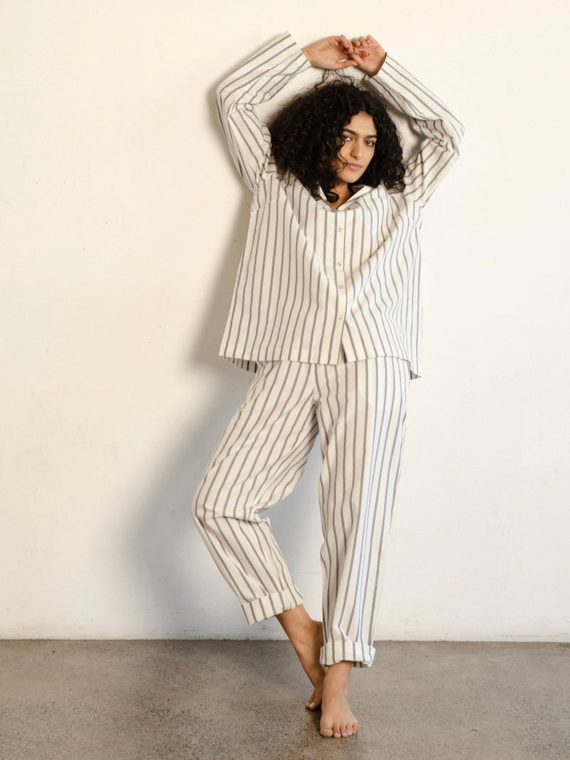 A woman wearing a general sleep Classic Set - Stripe pajama set.