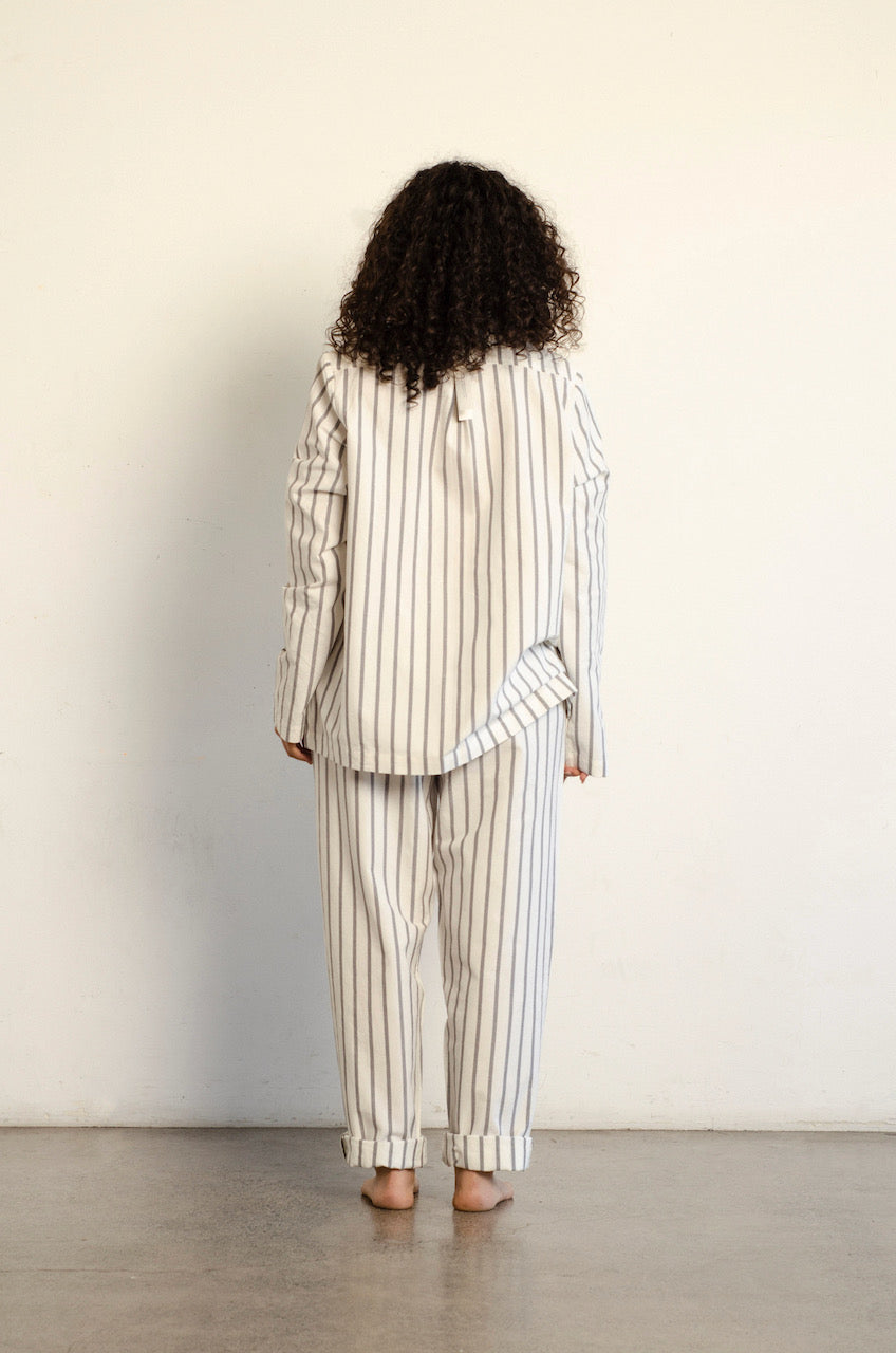 The back of a woman wearing a general sleep Classic Set - Stripe pajama set.
