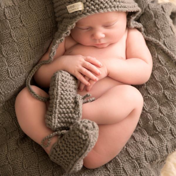 A baby sleeping in a Weebits Hand Knitted Chunky Booties - Mushroom hat.