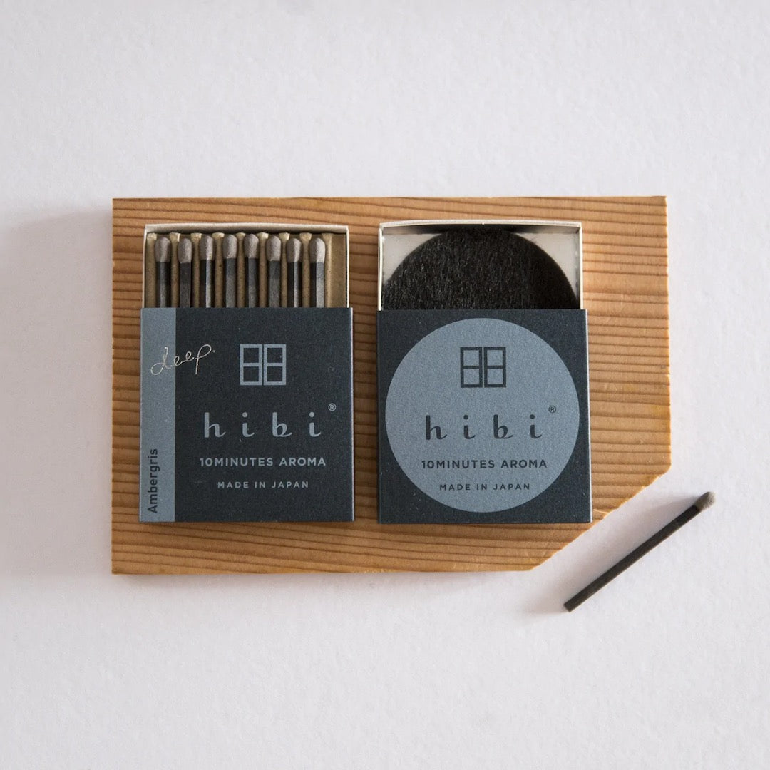 hibi incense sticks on a wooden board.