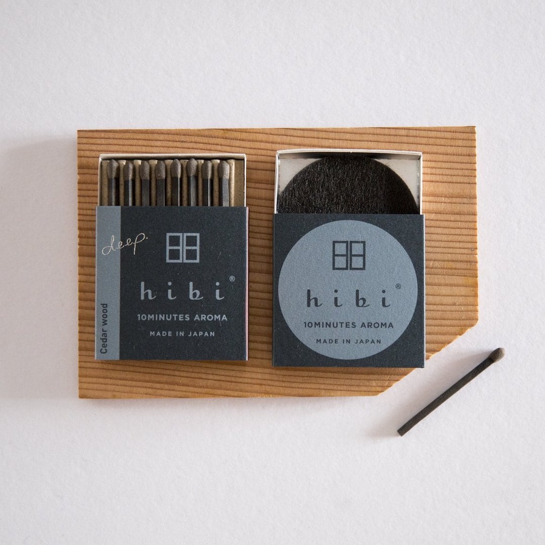 hibi incense sticks on a wooden board.