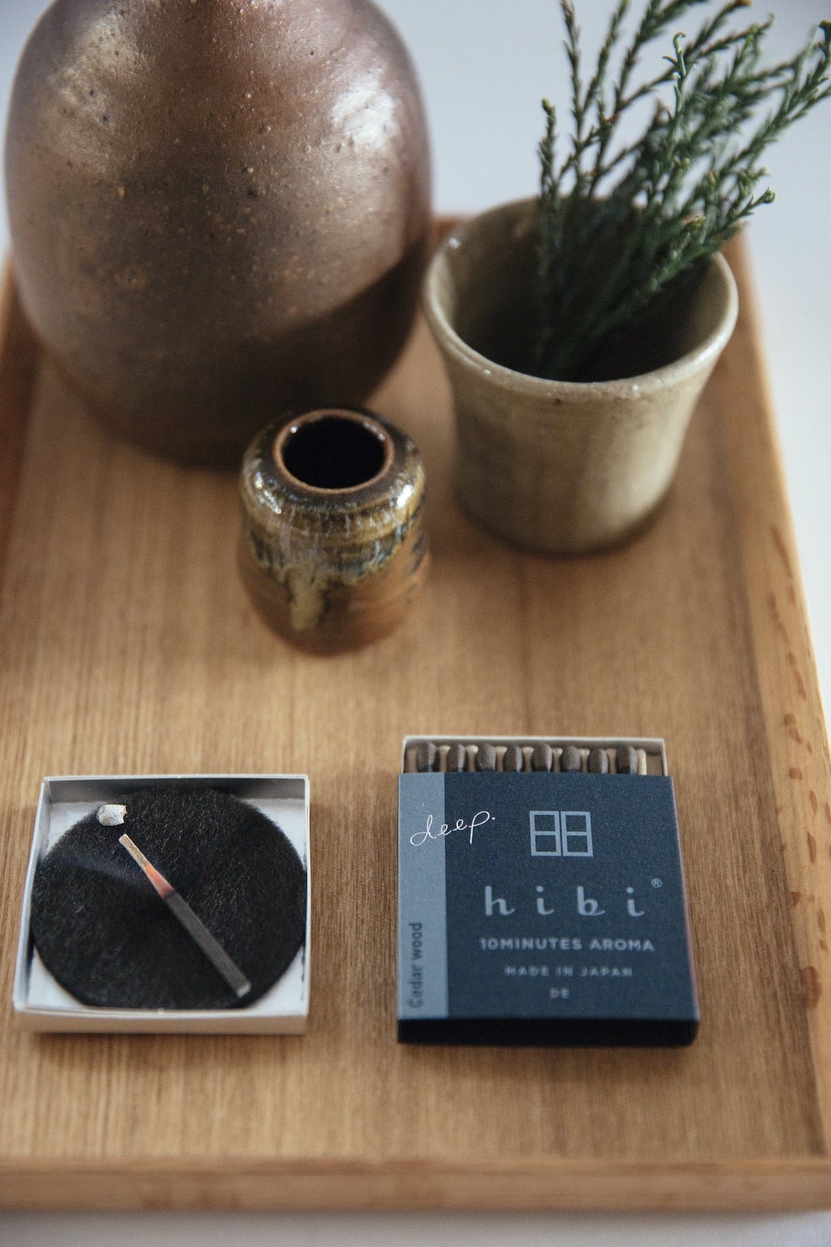 A tray with a pencil, a pen, and a Match Box Incense Deep – Cedar Wood by hibi.