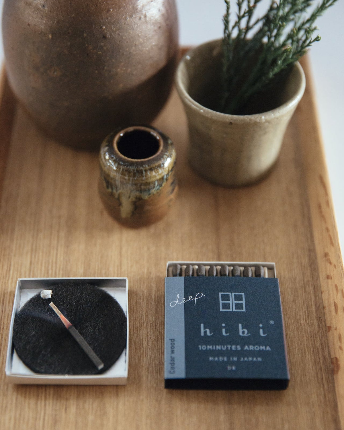 A tray with a pencil, a pen, and a Match Box Incense Deep – Cedar Wood by hibi.