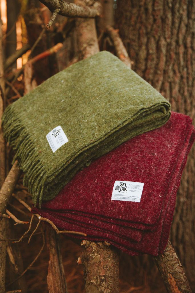 Two Moss Blankets - Fringe by Seljak Brand on top of a tree.