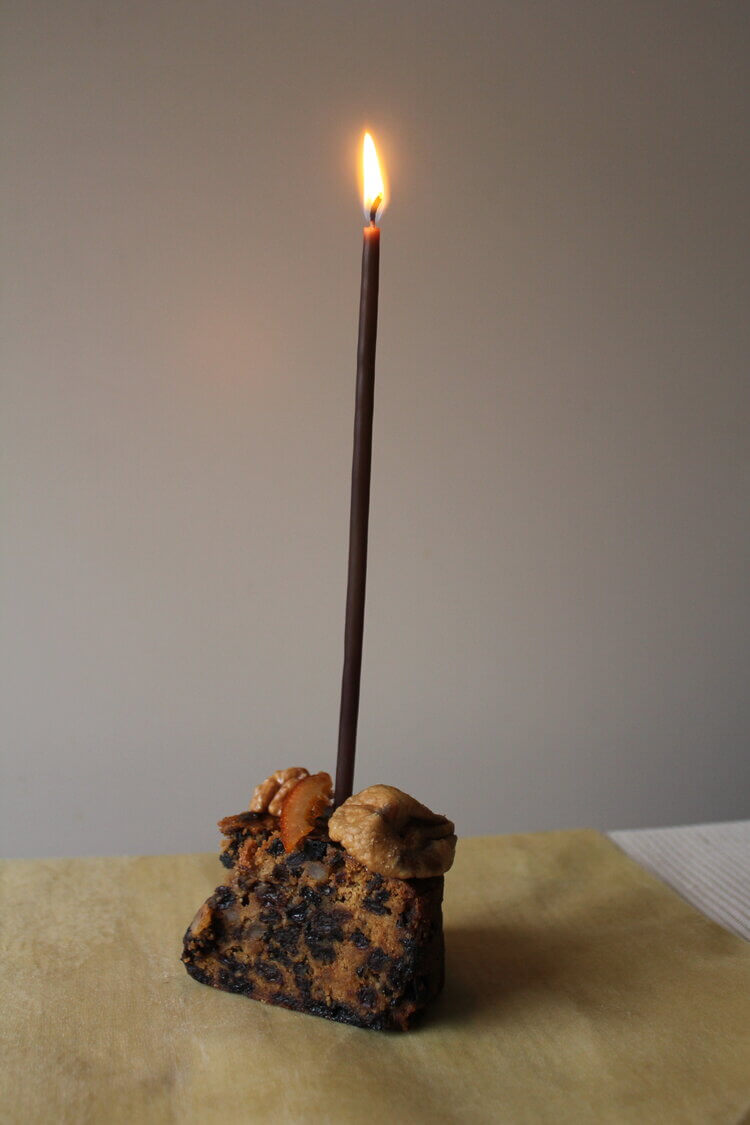A cake with 8 Celebration Candles – Double-dipped from Wax Atelier on top of it.