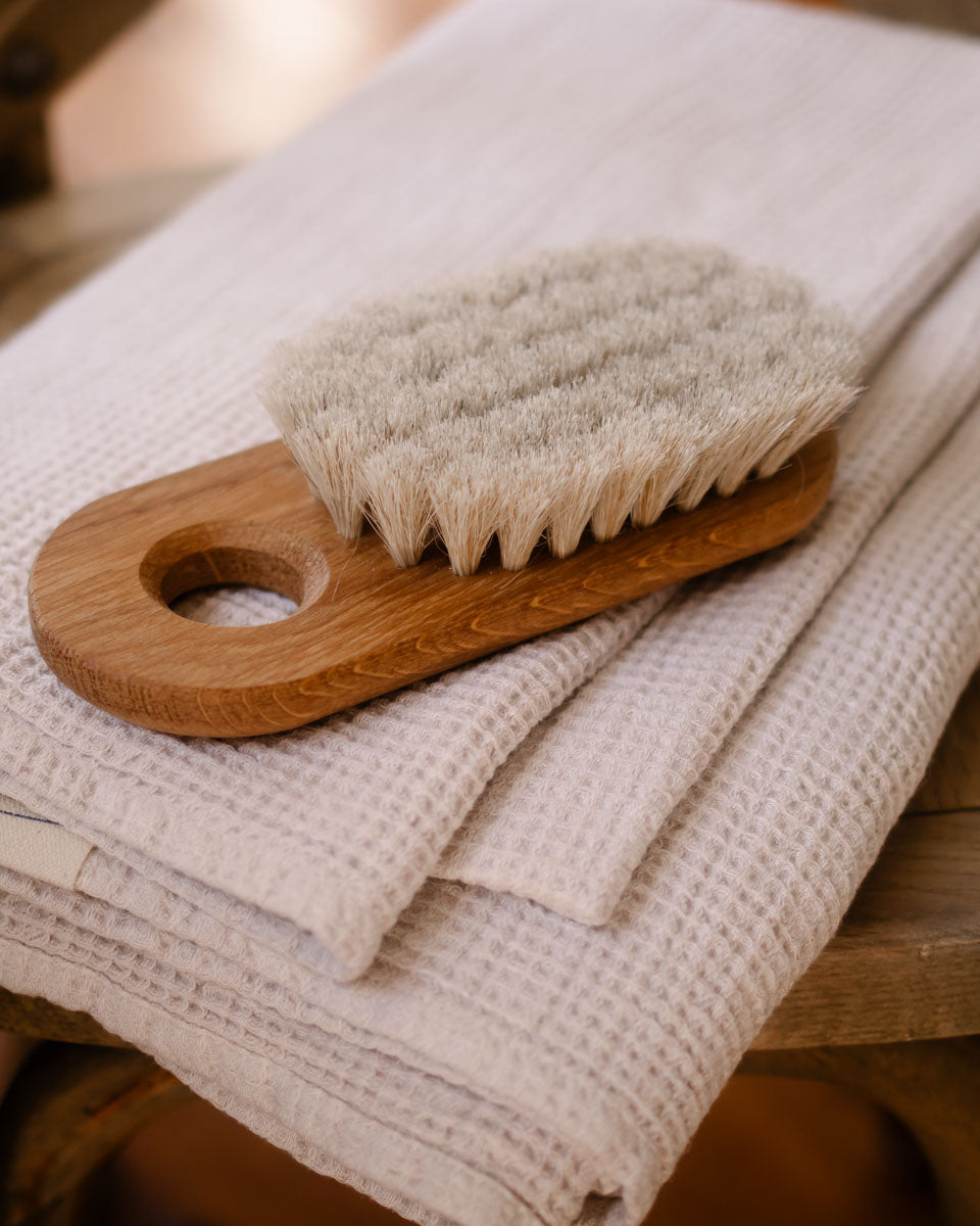 Two Iris Hantverk Body Brushes – Firm on a grey background.