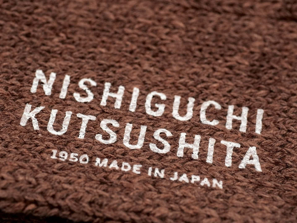 A Boston Slab Socks - Brown Fawn with the words Nishiguchi Kutsushita made in Japan.