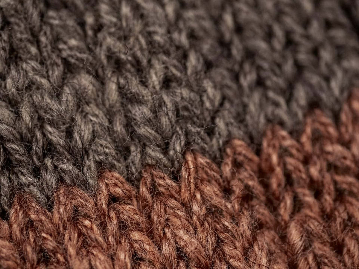 A close up of a Boston Slab Socks – Brown Fawn knitted sweater by Nishiguchi Kutsushita.