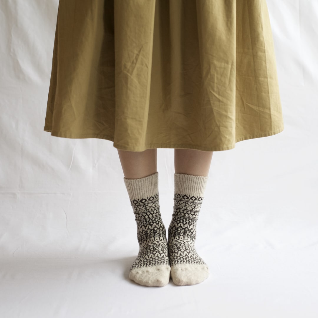 A woman wearing an Oslo Wool Jacquard Socks – Oatmeal by Nishiguchi Kutsushita.