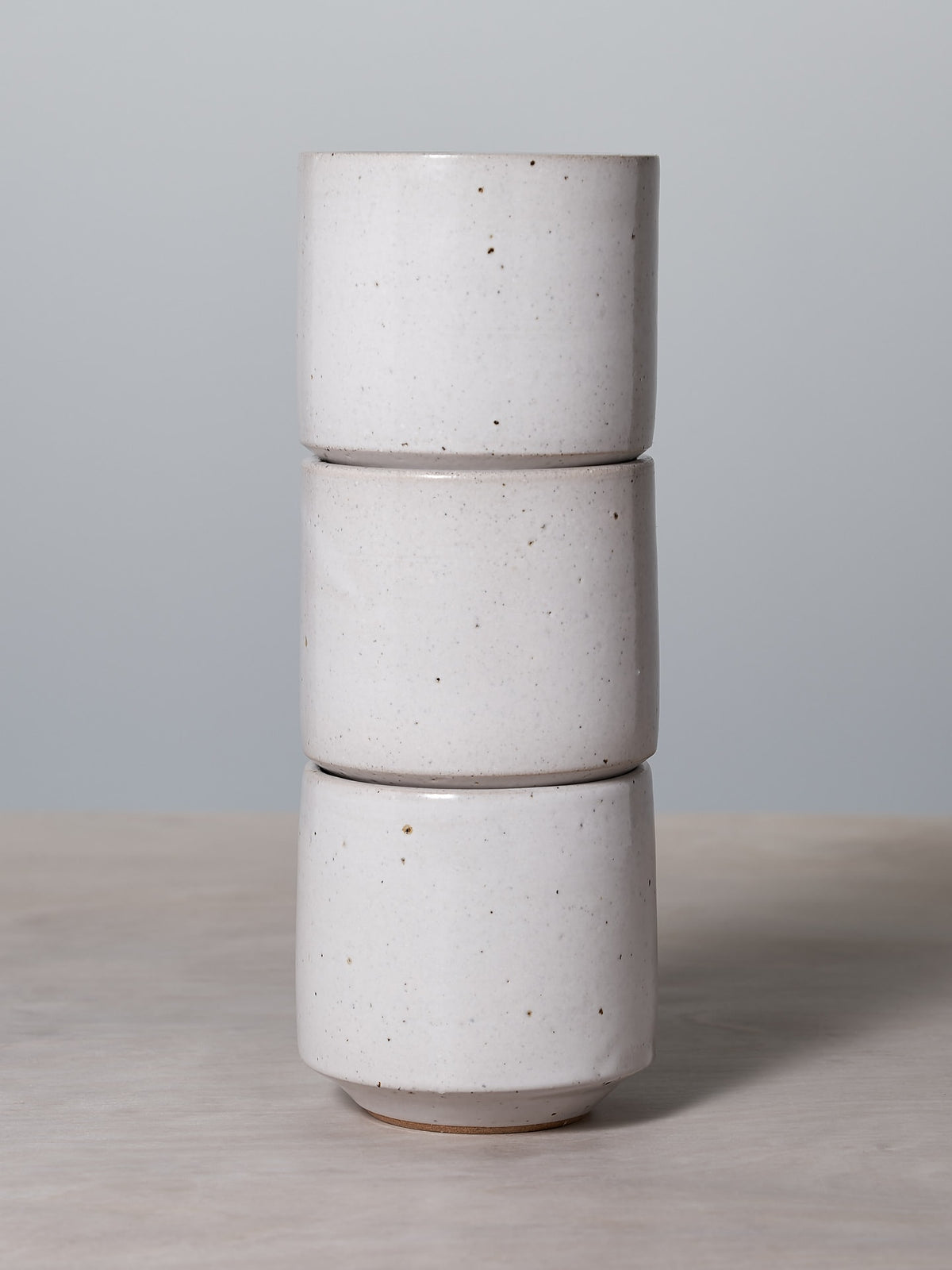 Three stacks of Richard Beauchamp Stacking Tumblers on a wooden table.